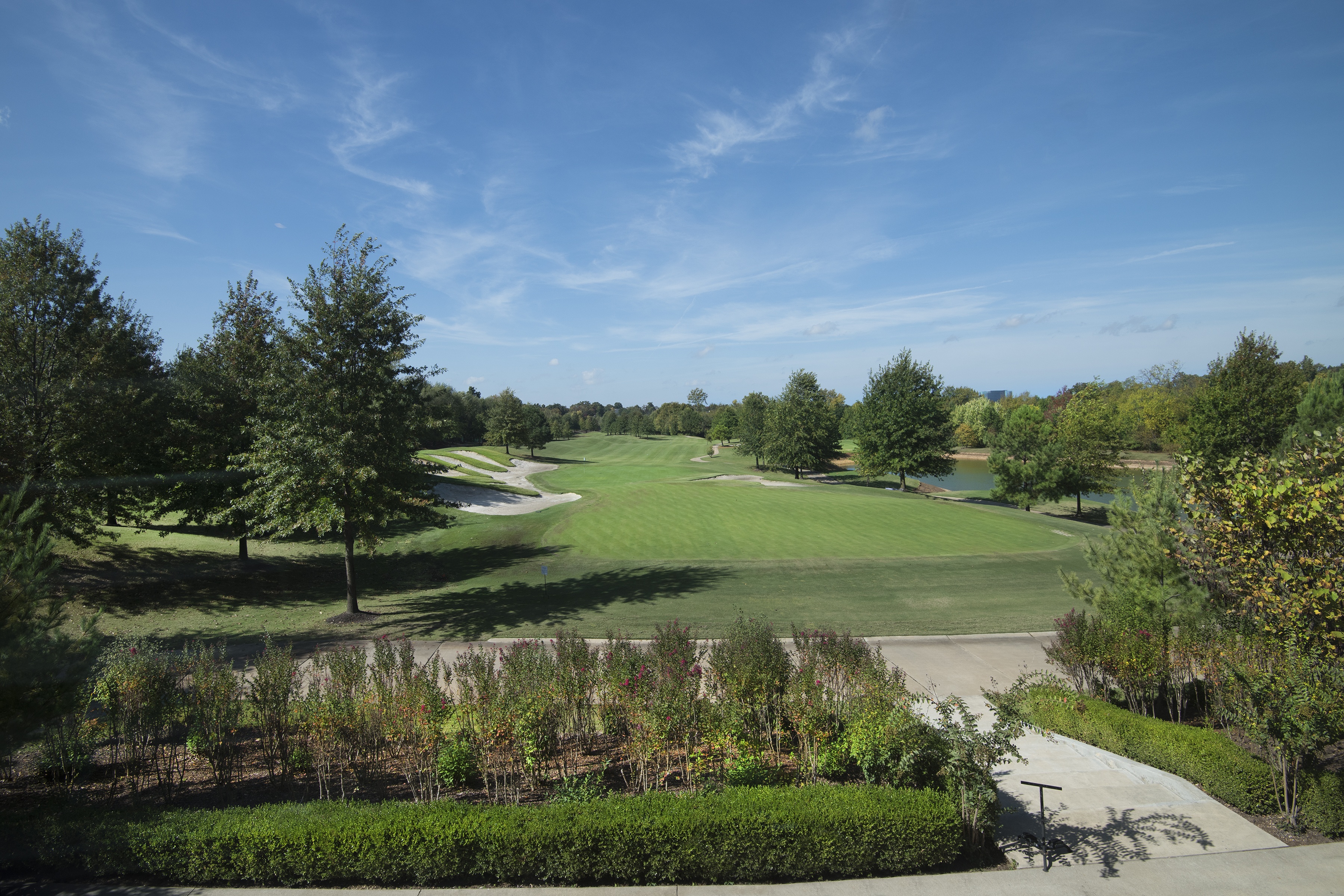 A golf course with a clear blue sky above.